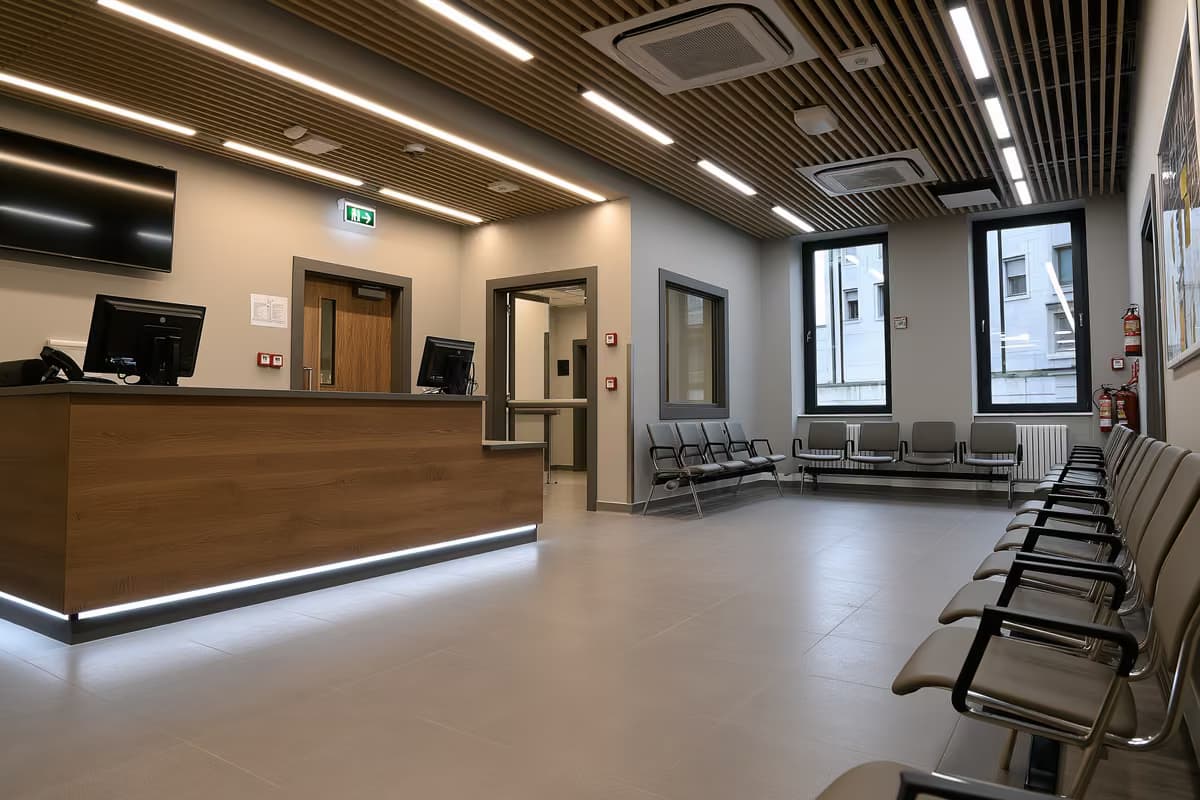 An official service counter and empty waiting chairs in a quiet public office.