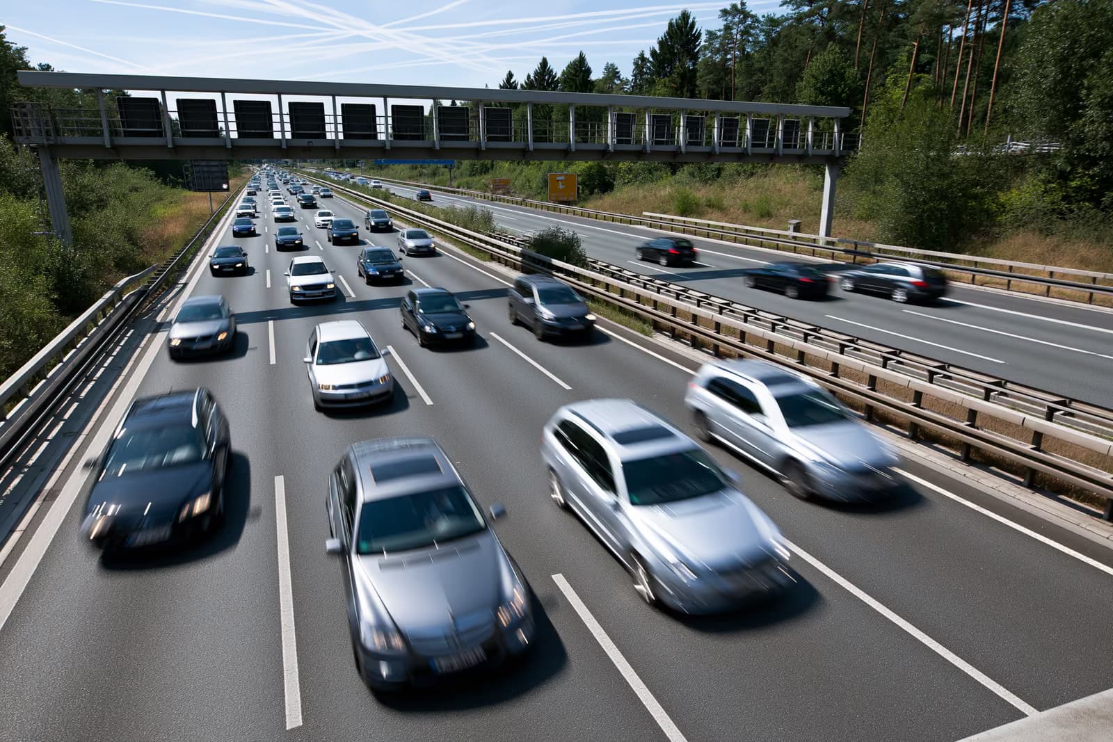 Cars flowing along a German motorway on a bright summer day.