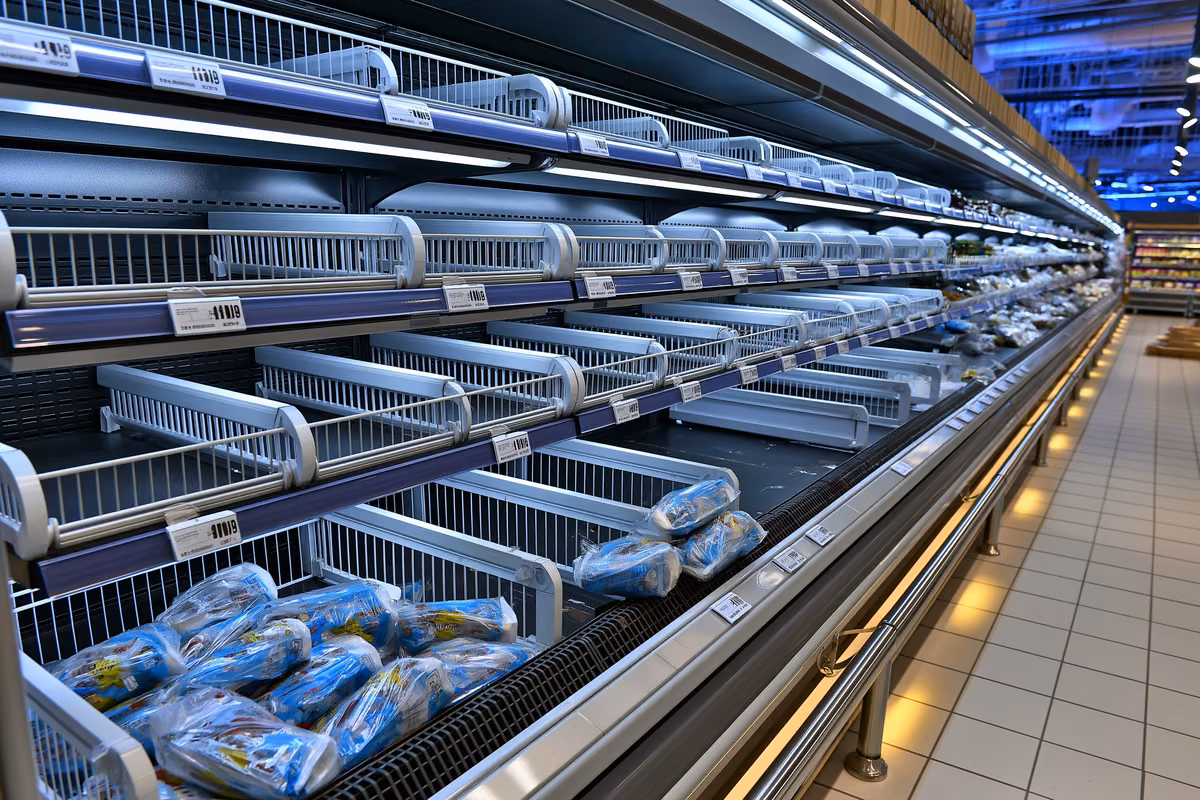 An empty refrigerated supermarket shelf with a few remaining packs after the sausage recall in Germany