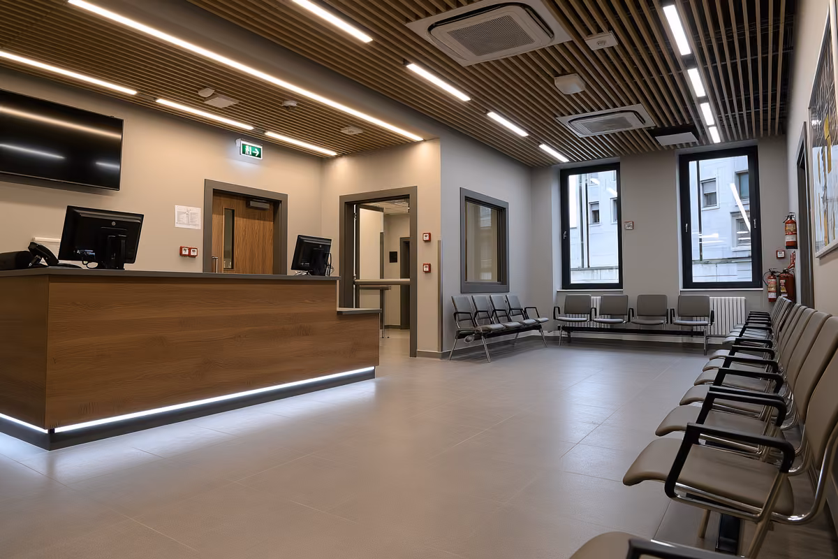 An official service counter and empty waiting chairs in a quiet public office.