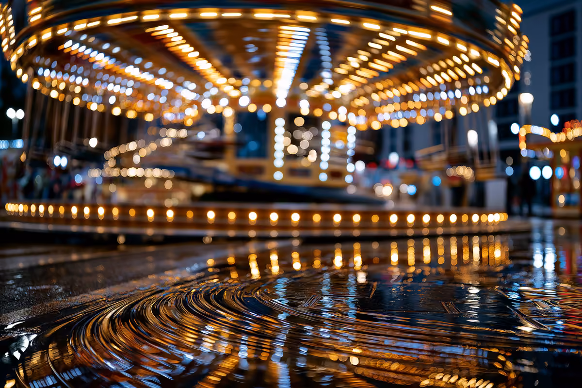 Fireworks bursting over the illuminated rides of a German summer funfair at night